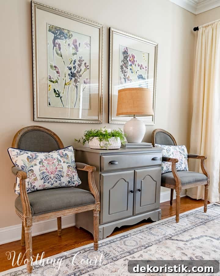 gray dining chairs beside gray chest with multi colored artwork