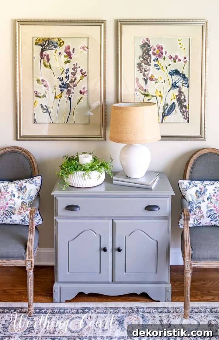 gray dining chairs beside gray chest with multi colored artwork