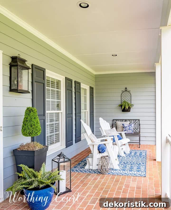 front porch with white Adirondack style gliders and blue and white spring decor