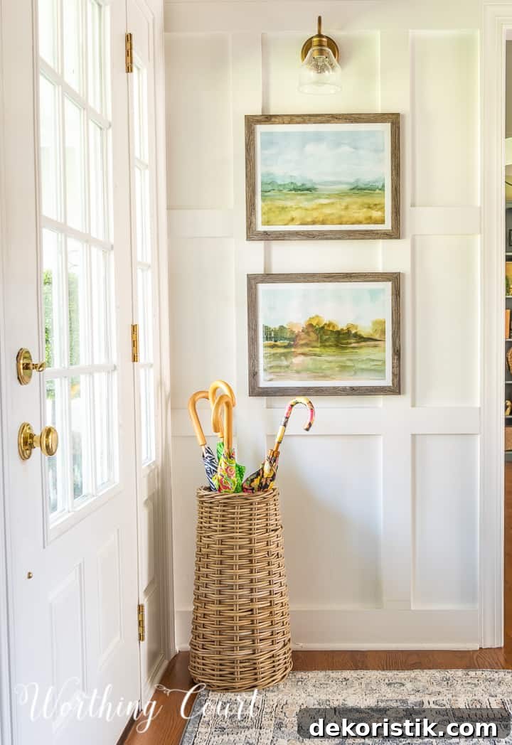basket umbrella stand with assorted umbrellas in a foyer with white walls