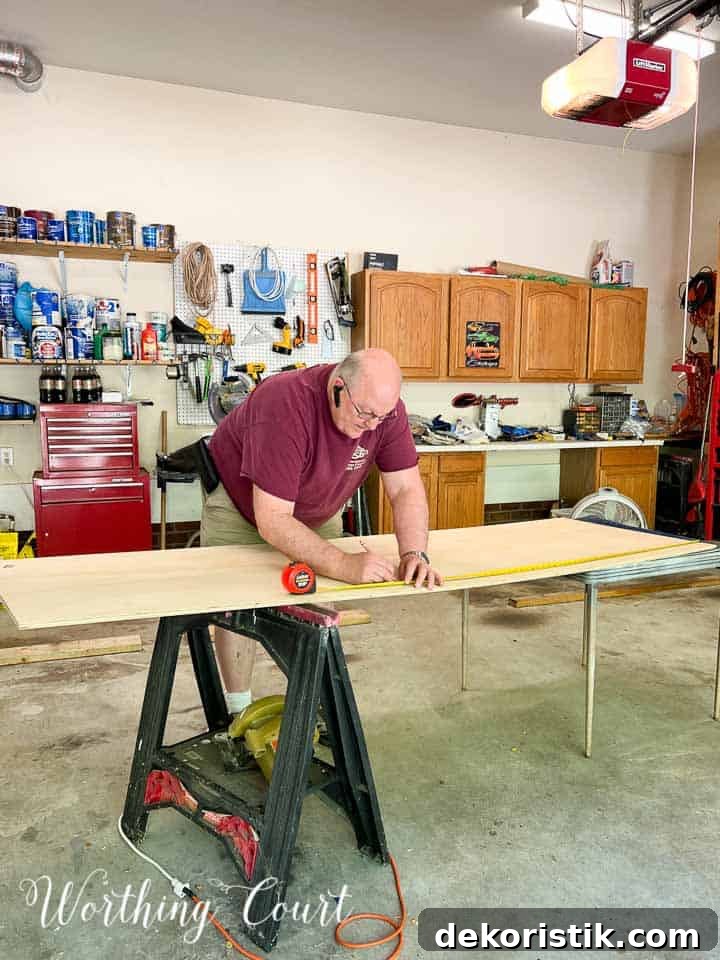 man working a piece of plywood
