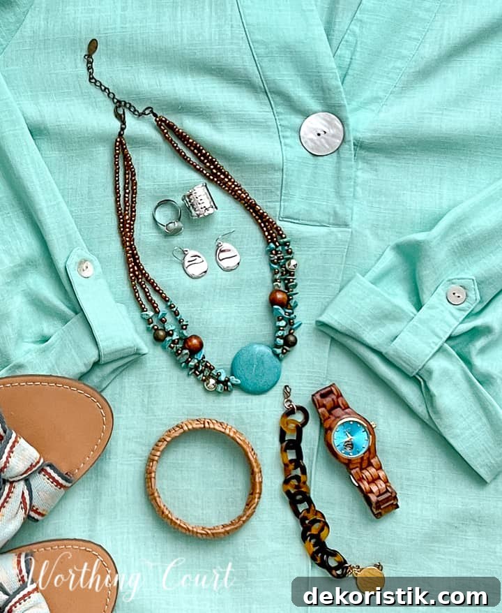 various jewelry lying in an aqua shirt