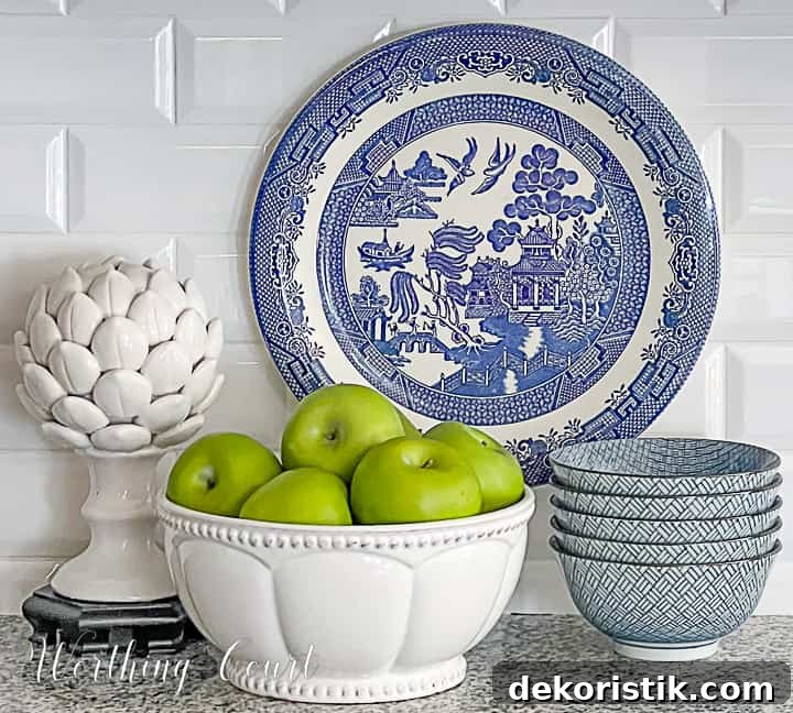 blue and white vignette with green apples in a bowl in a kitchen counter