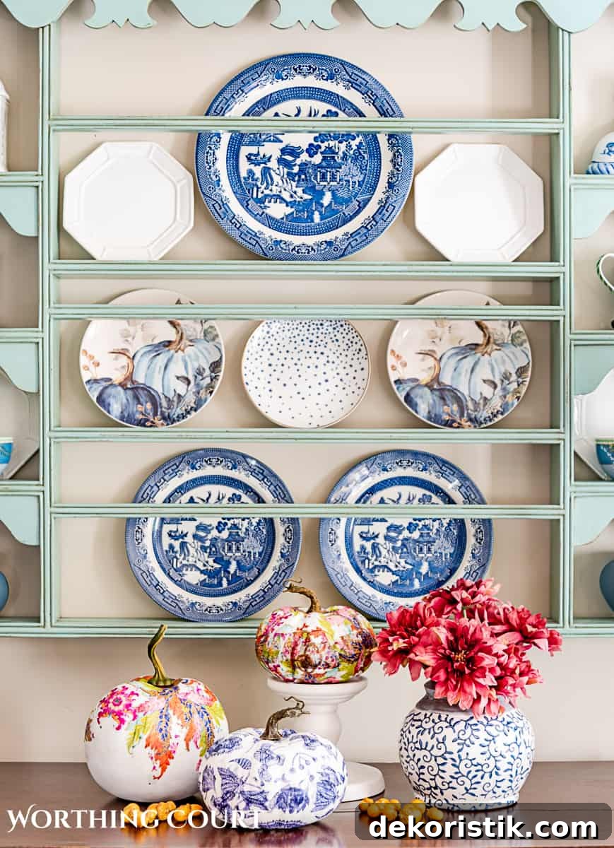 DIY Chinoiserie Pumpkins for Elegant Fall Decor 3 display of three diy chinoiserie pumpkins in front of a plate rack