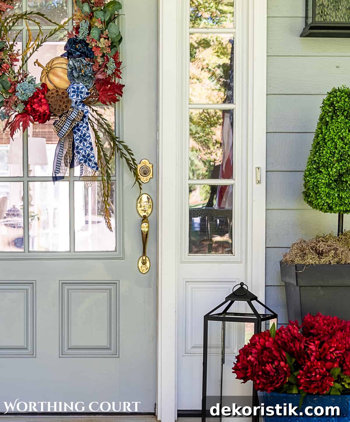 blue and burgundy fall front porch decor featuring a diy wreath, topiaries and faux mums