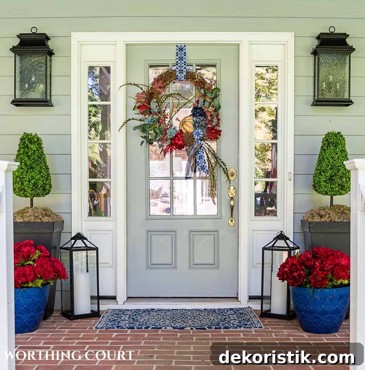 blue and burgundy fall front porch decor featuring a diy wreath, topiaries and faux mums