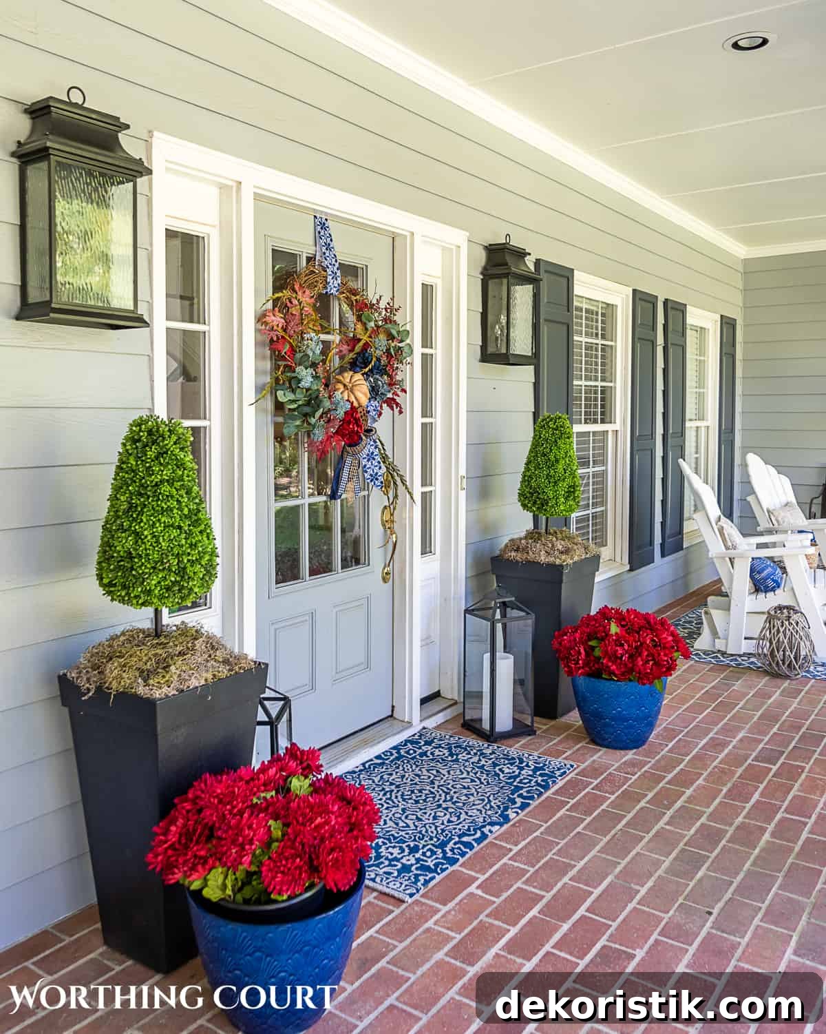 blue and burgundy fall front porch decor featuring a diy wreath, topiaries and faux mums