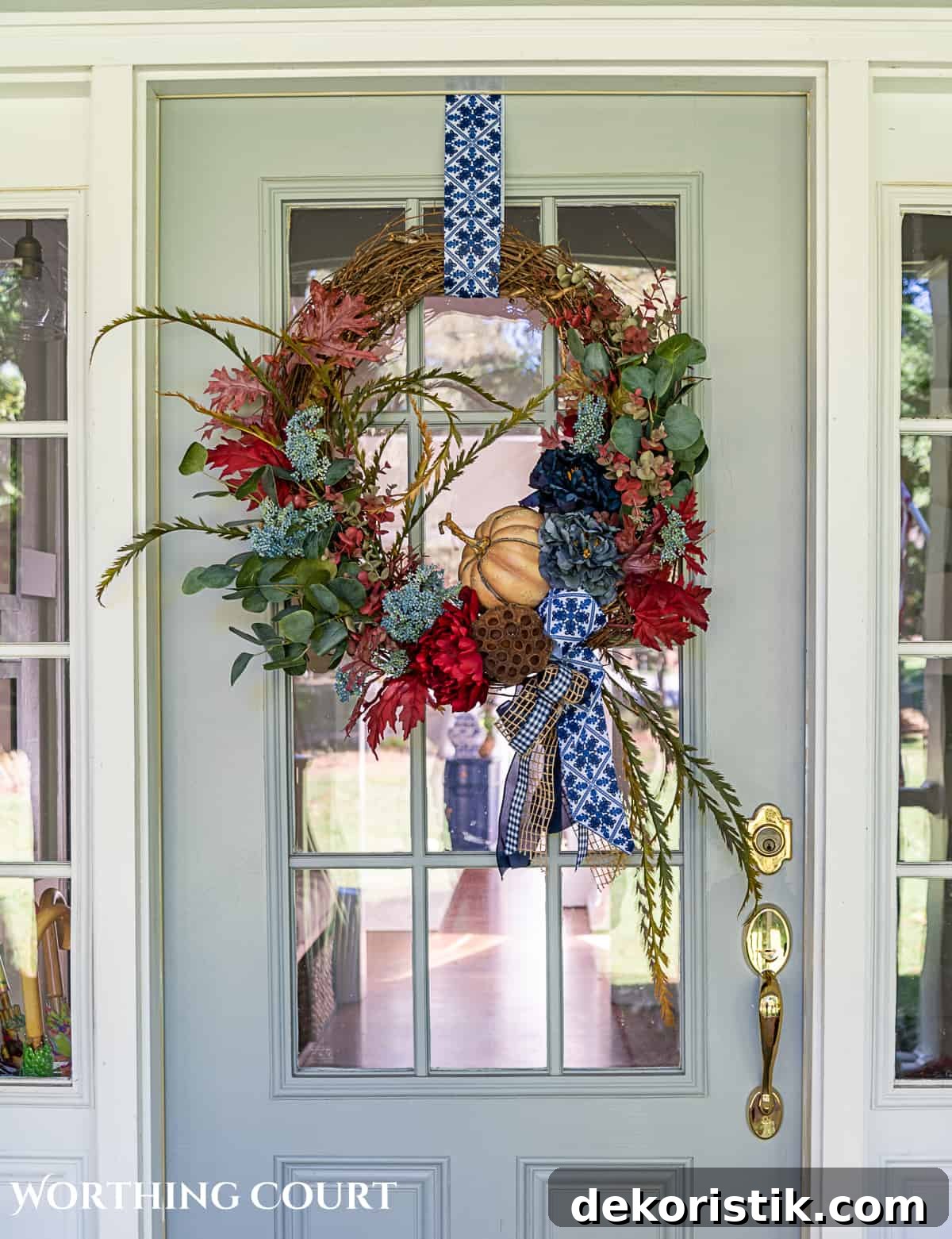 blue and burgundy fall front porch decor featuring a diy wreath, topiaries and faux mums