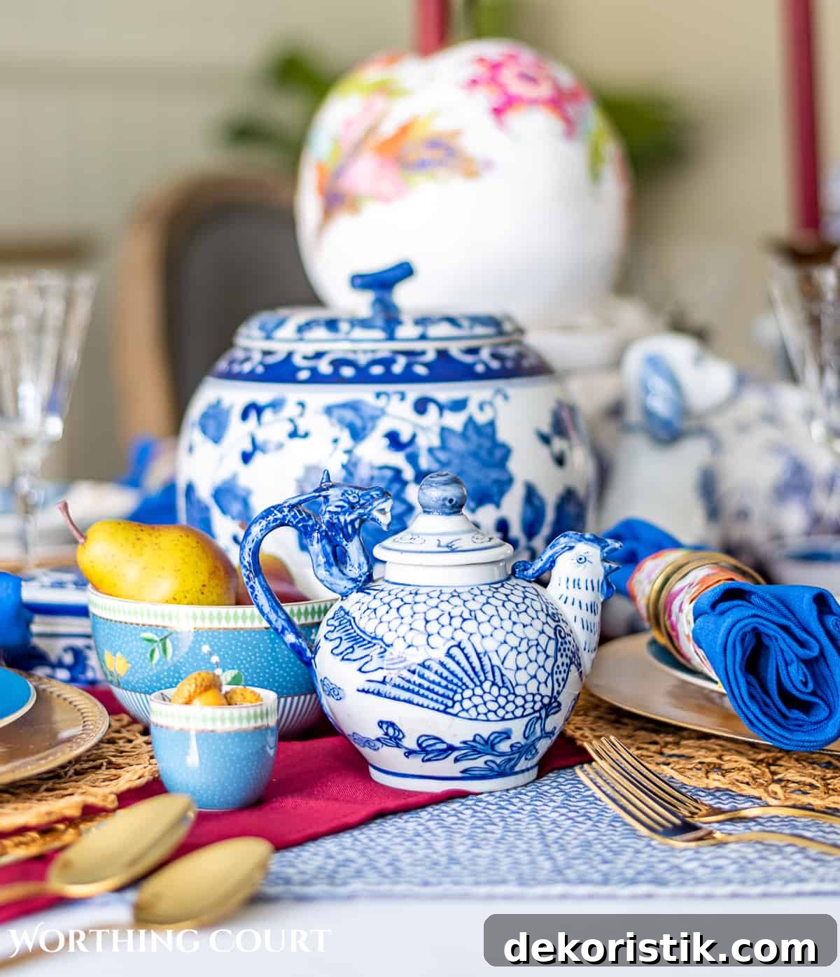 blue and white thanksgiving table setting with touches of burgundy