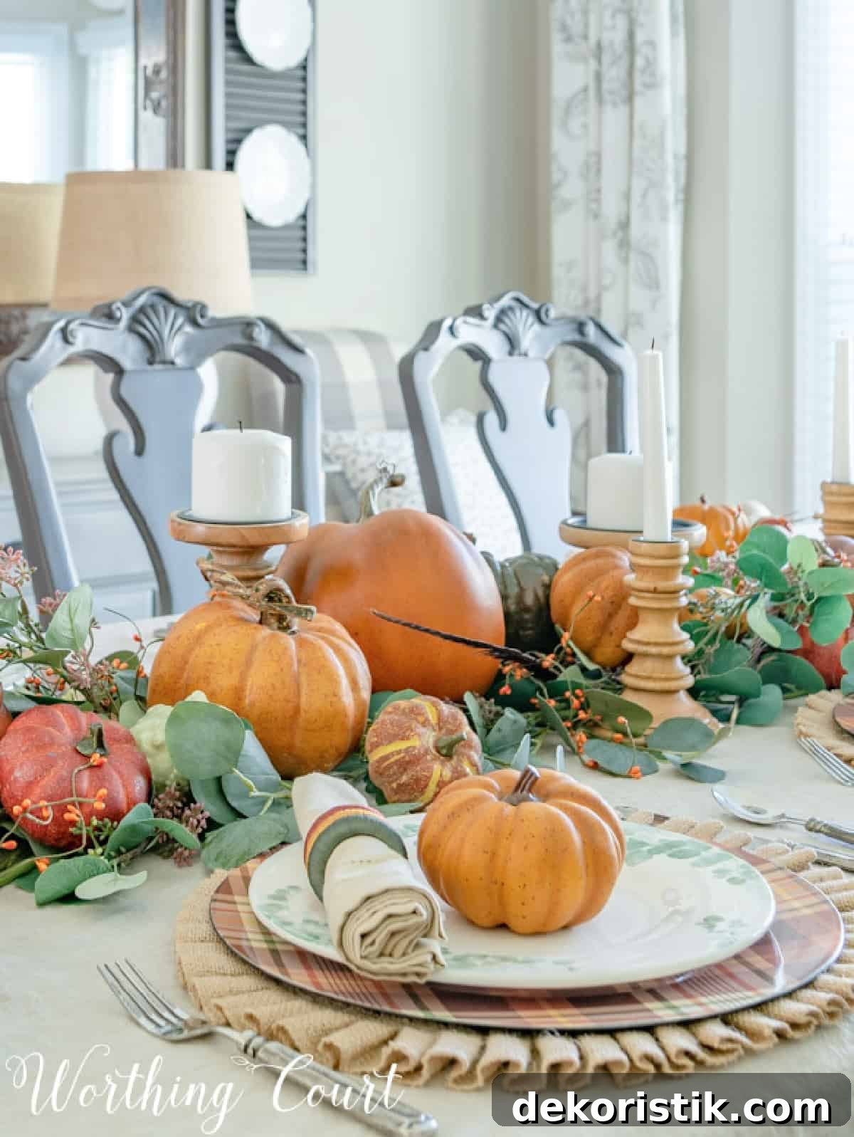 portion of thanksgiving tablescape with fall colors and eucalyptus in the centerpiece