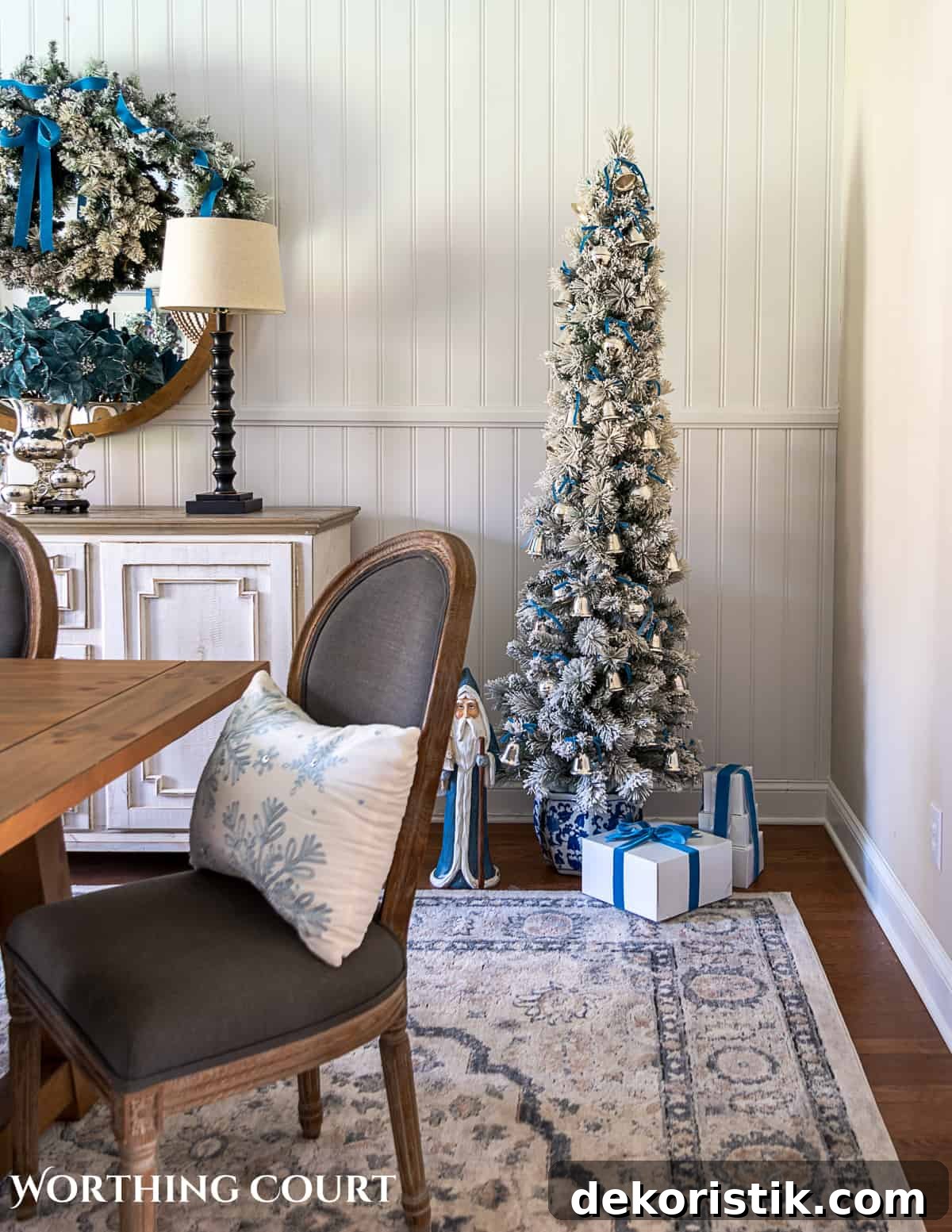 Flocked pencil Christmas tree decorated with French blue and silver ornaments and ribbon