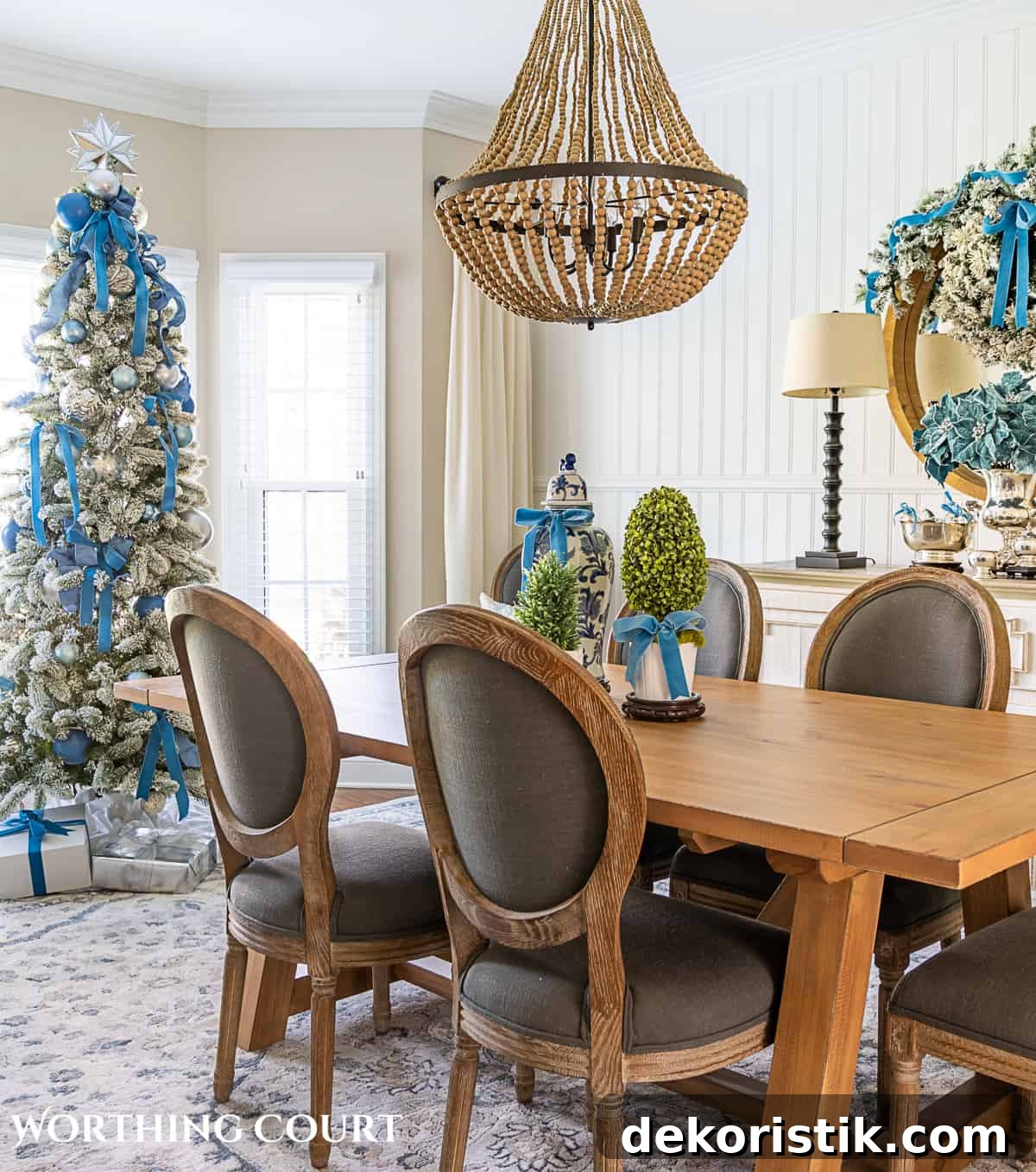 Dining room decorated for Christmas with French blue and silver with a flocked Christmas tree