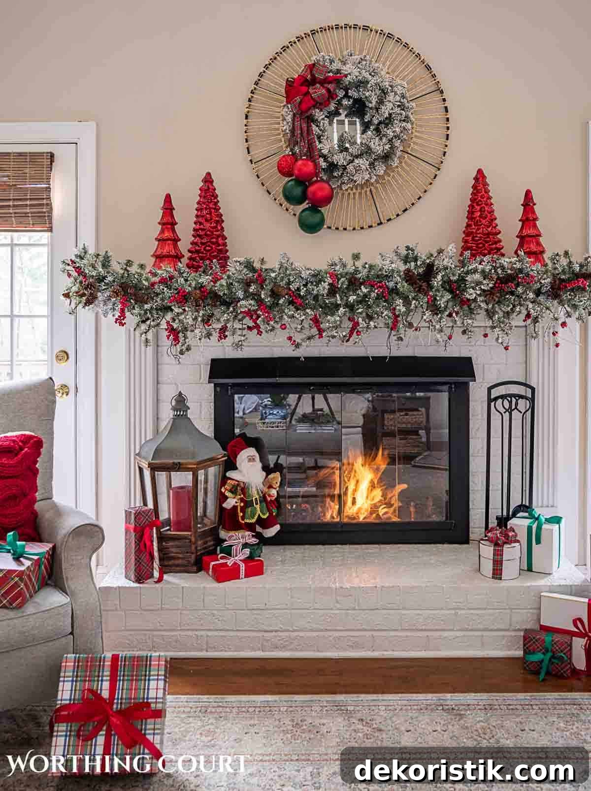Christmas tree, fireplace and living room decorated for Christmas with red green and gold decorations