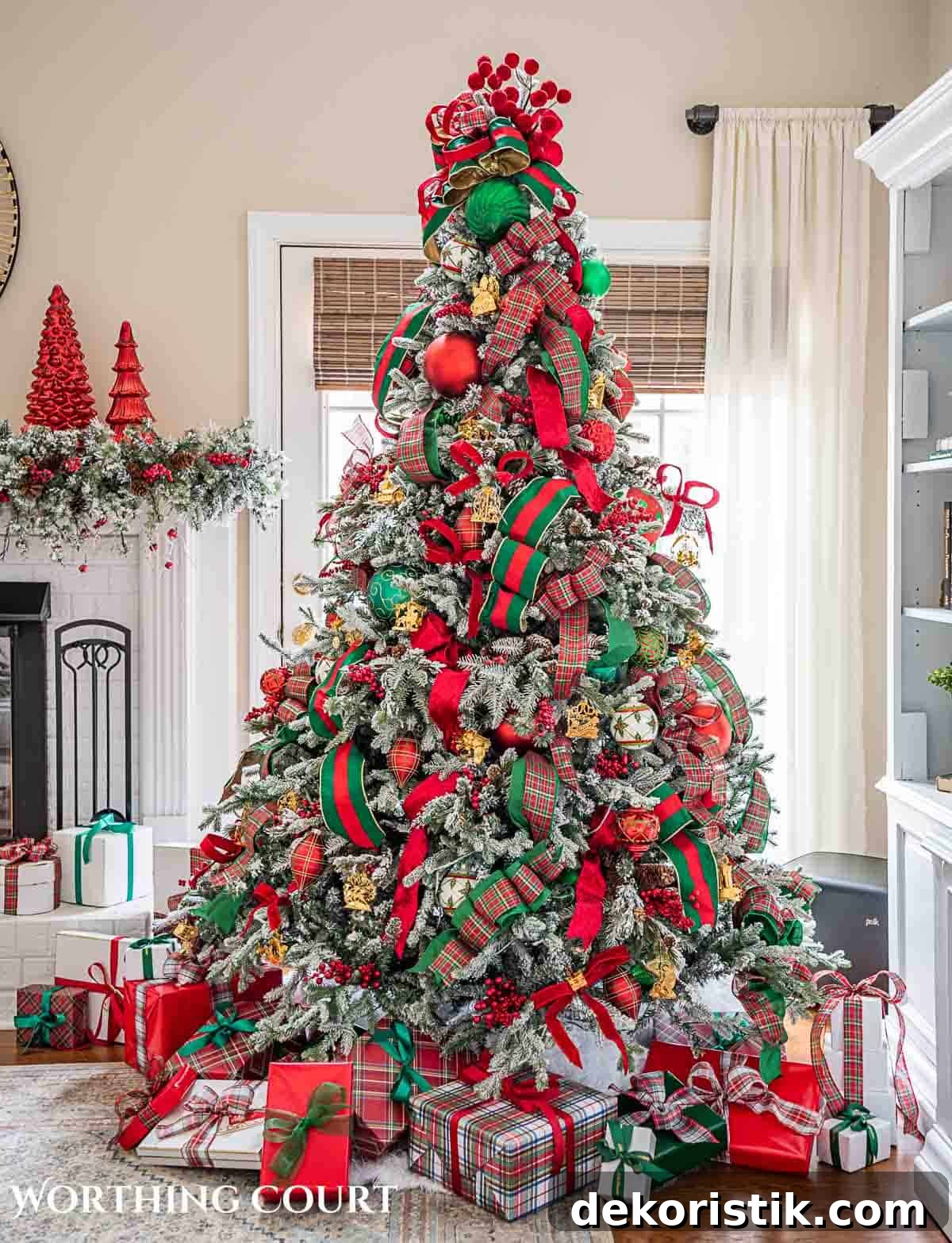Christmas tree, fireplace and living room decorated for Christmas with red green and gold decorations