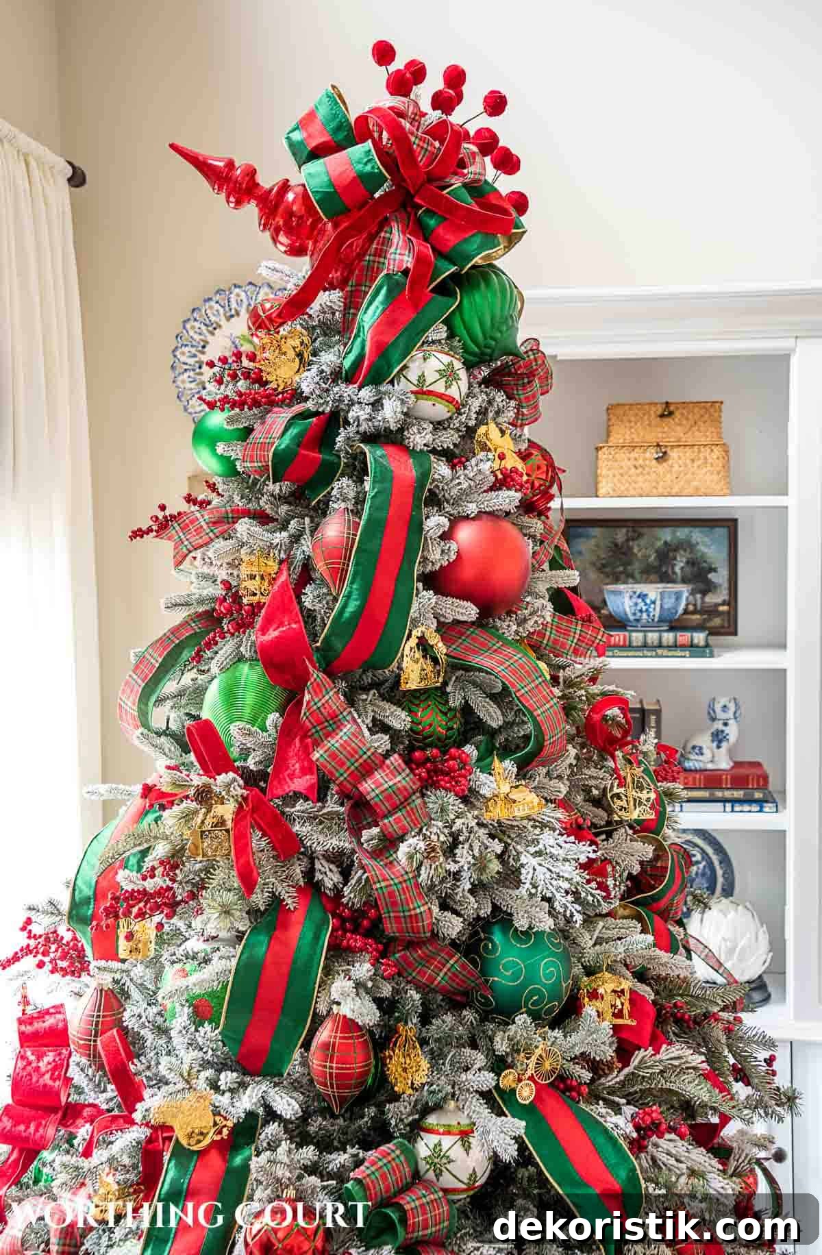 Christmas tree, fireplace and living room decorated for Christmas with red green and gold decorations