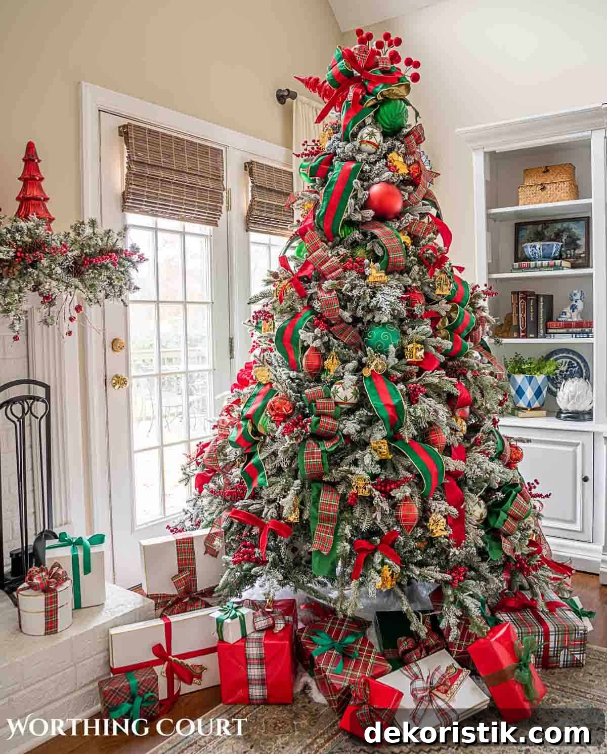 Christmas tree, fireplace and living room decorated for Christmas with red green and gold decorations