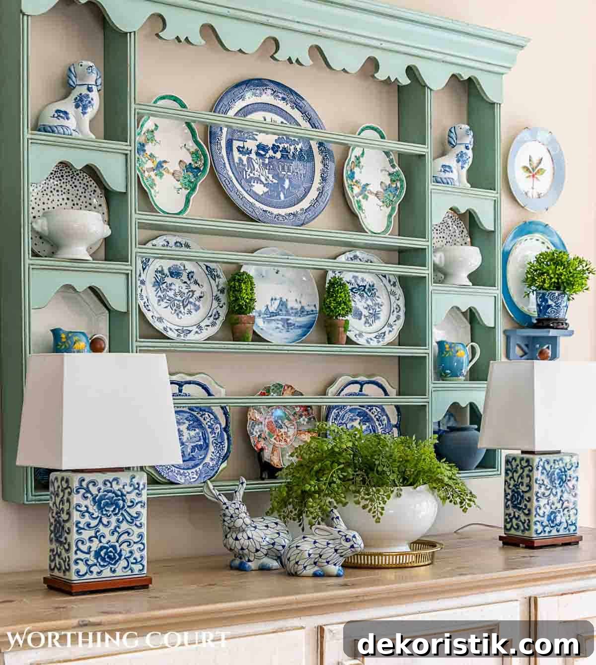 white sideboard with blue plate rack above filled with spring dishes and greenery