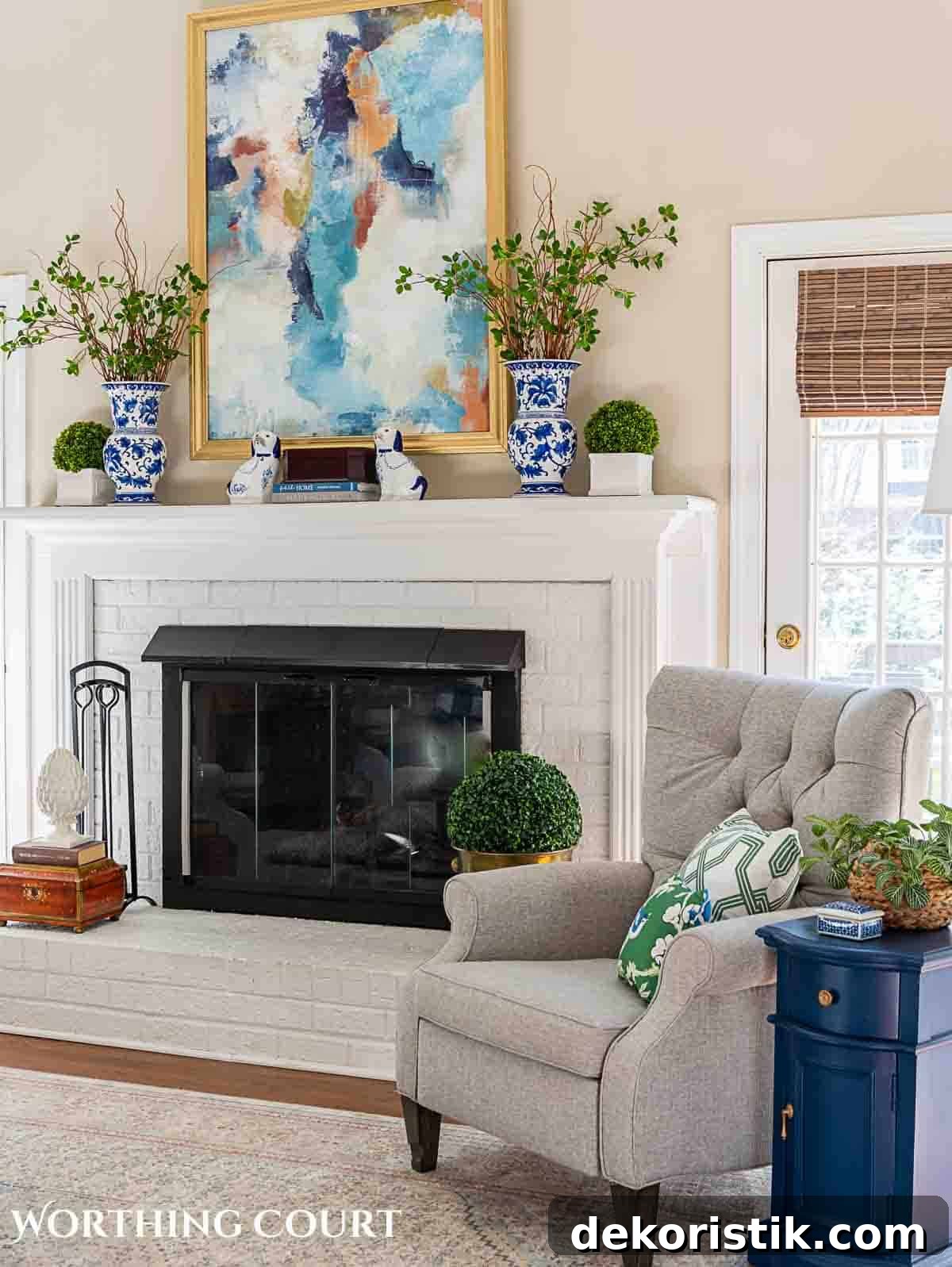 living room spring decorations with greenery stems in blue and white vases on a white brick fireplace mantel