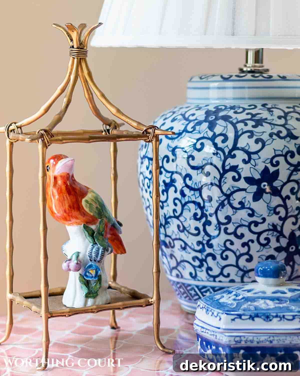 bird figurine in an open brass lantern next to a bue and white lamp
