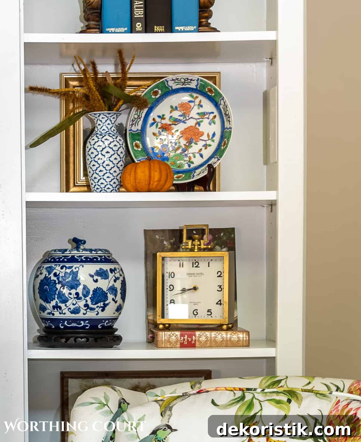 diy fall decorations on the shelves of a white entertainment center