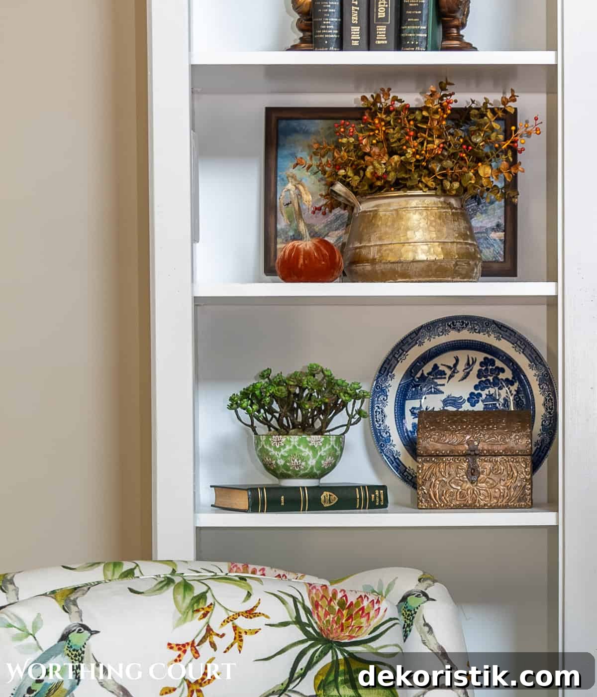 diy fall decorations on the shelves of a white entertainment center