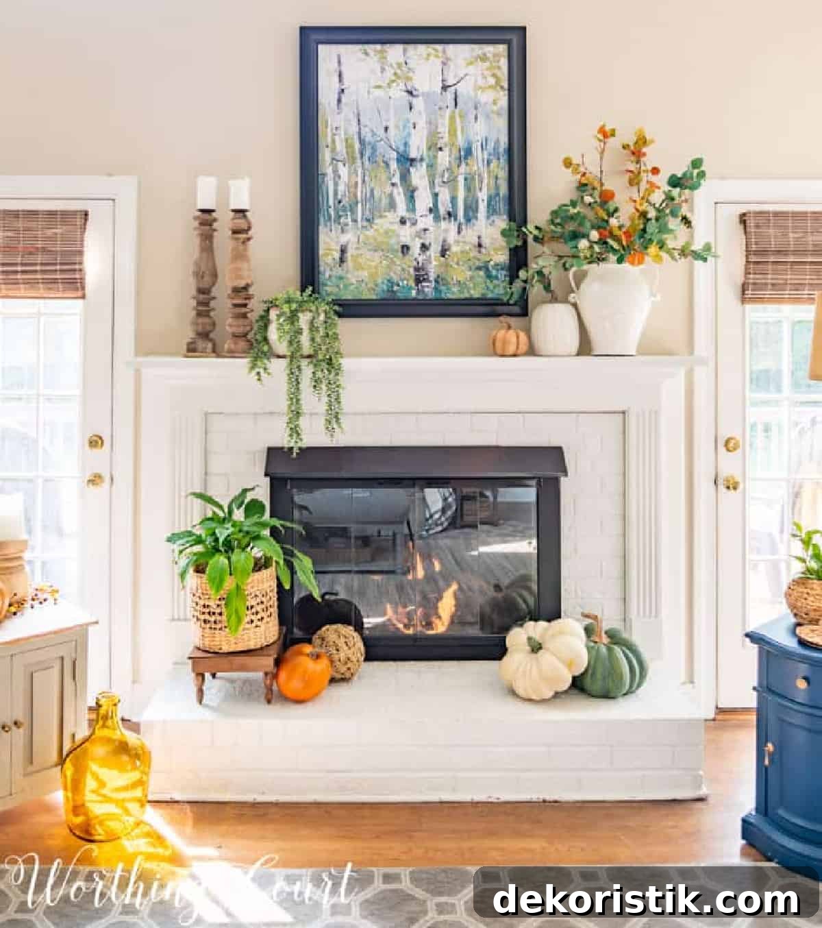 fall decorations on a white brink fireplace and mantel
