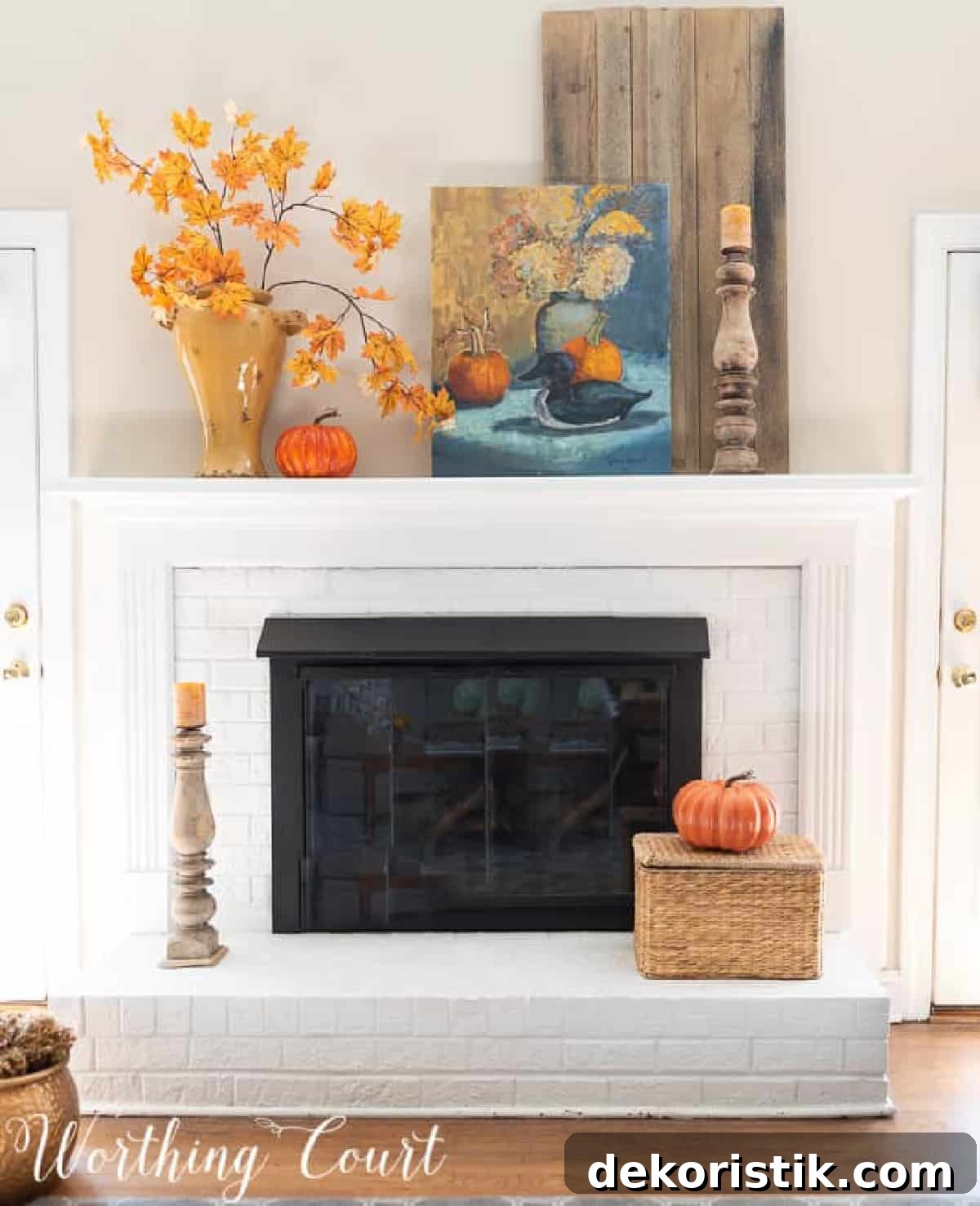 fall decorations on a white brink fireplace and mantel