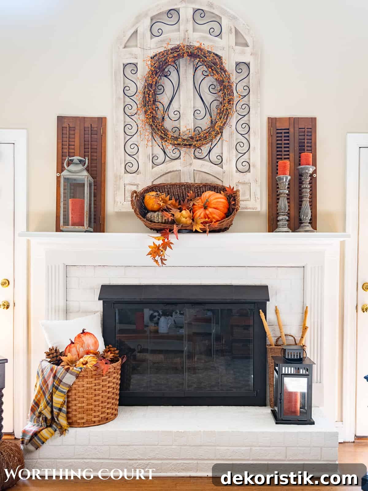 fall decorations on a white brink fireplace and mantel