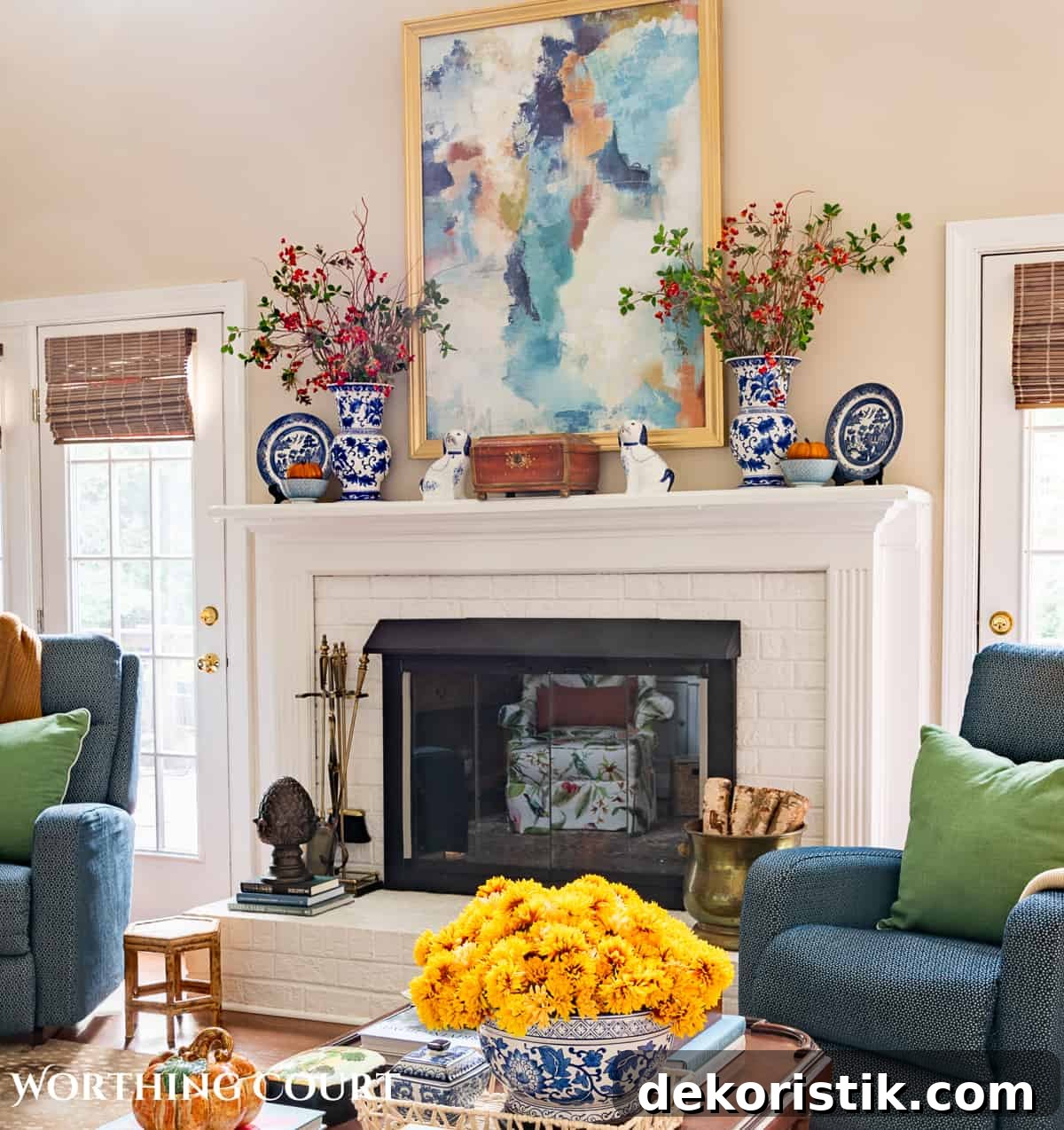 fall decorations on a white brink fireplace and mantel