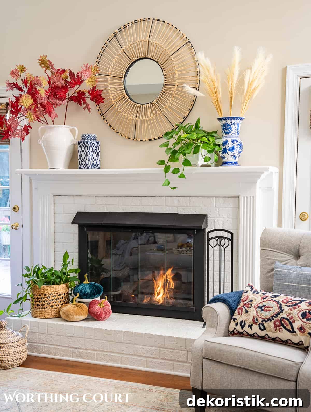 fall decorations on a white brink fireplace and mantel