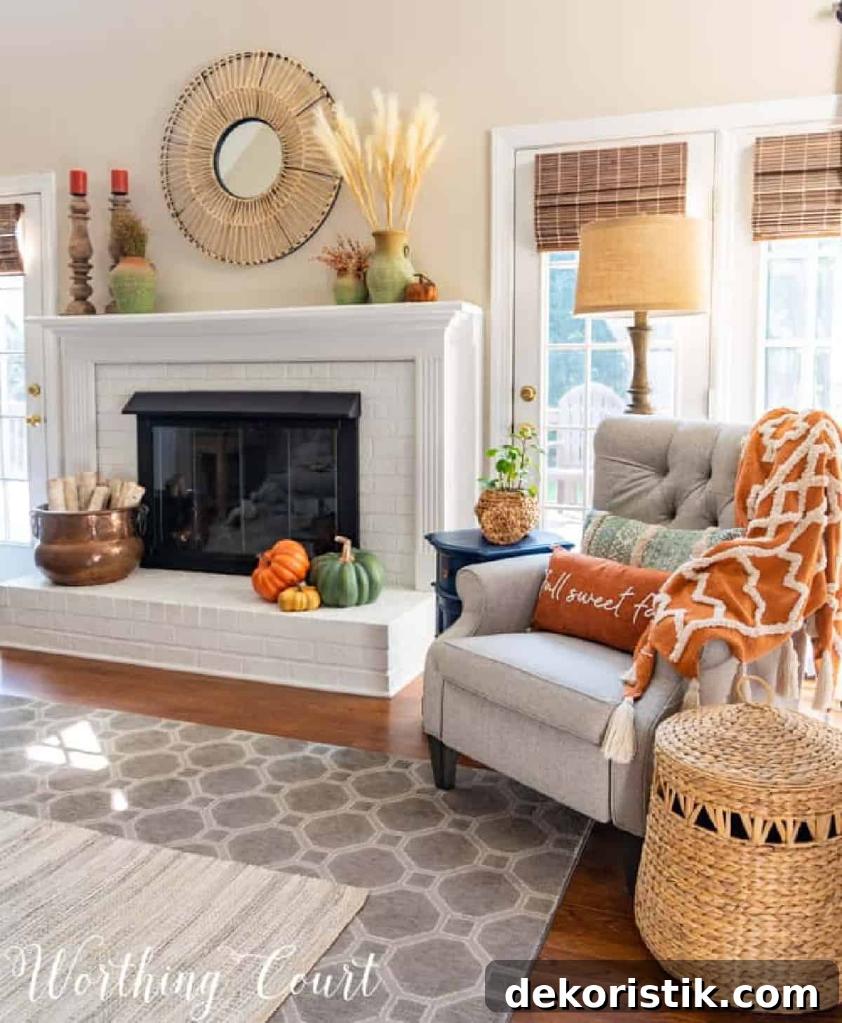 fall decorations on a white brink fireplace and mantel