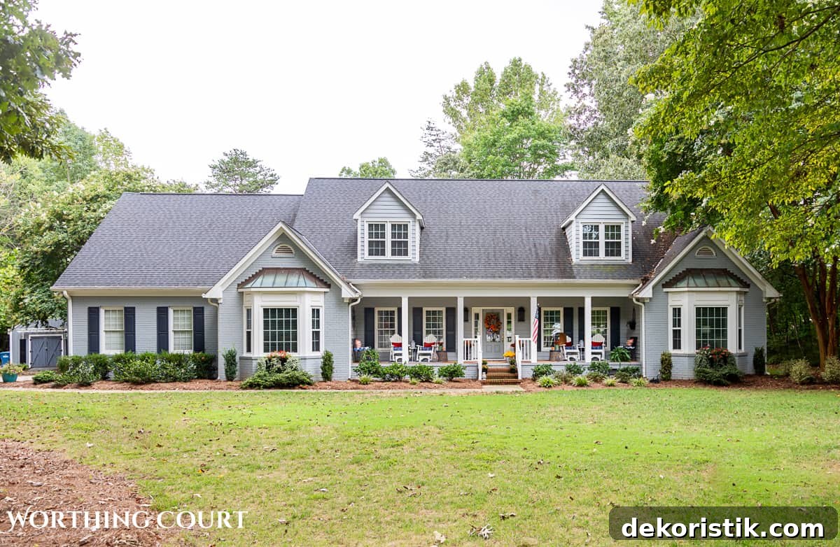 exterior of gray house with a large front porch decorated for fall
