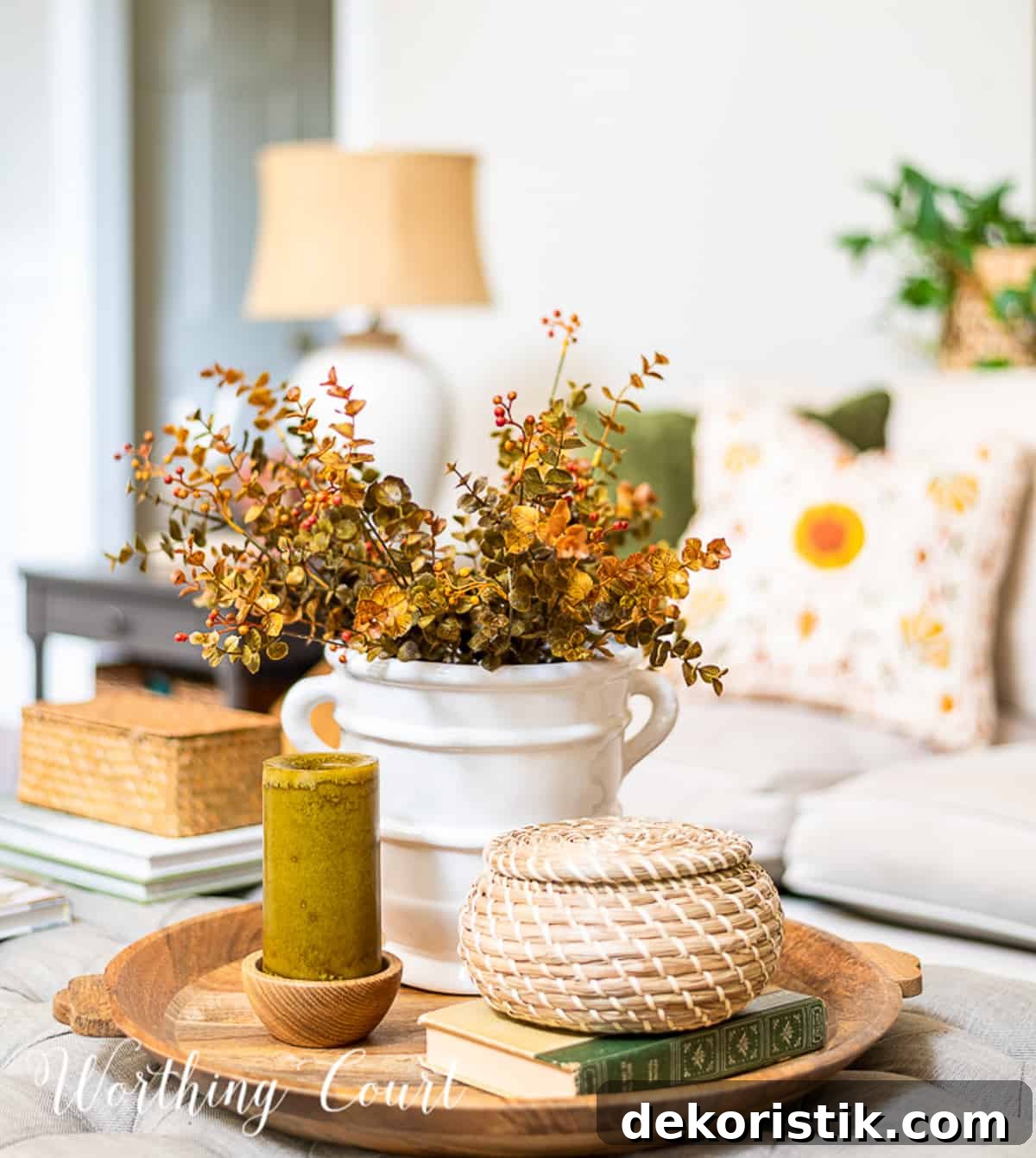 fall vignette on a round wood tray on a coffee table