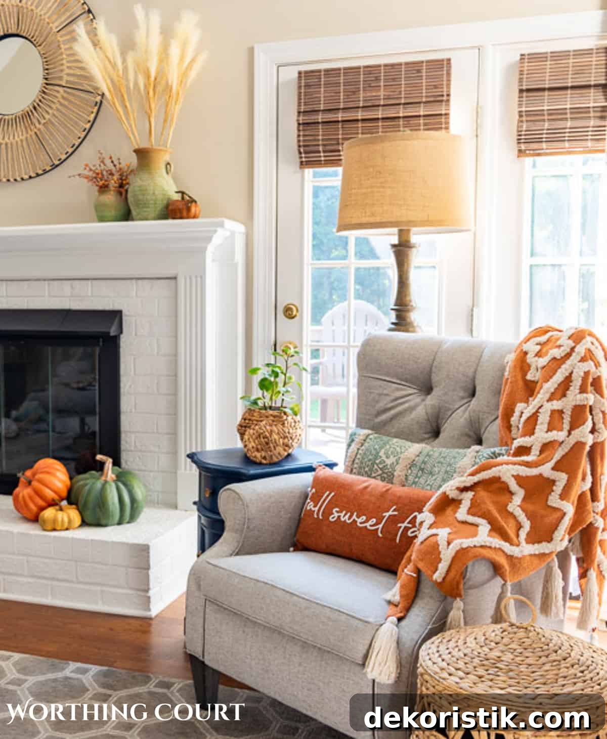 plush fall throw blanket over a gray arm chair in front of a fireplace with fall decor to demonstrate a fall aesthetic