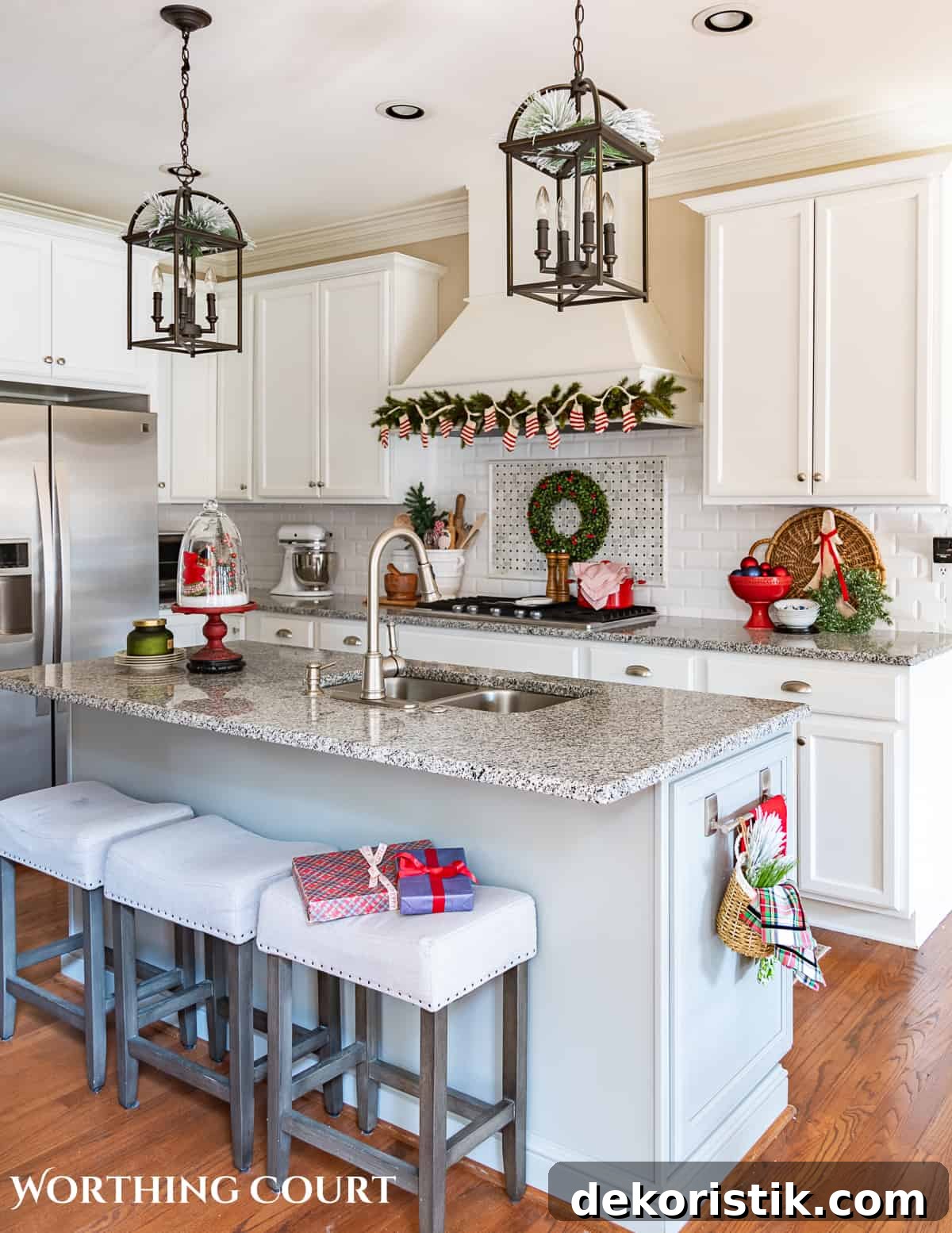 Christmas decorations in kitchen with white cabinets and a gray island