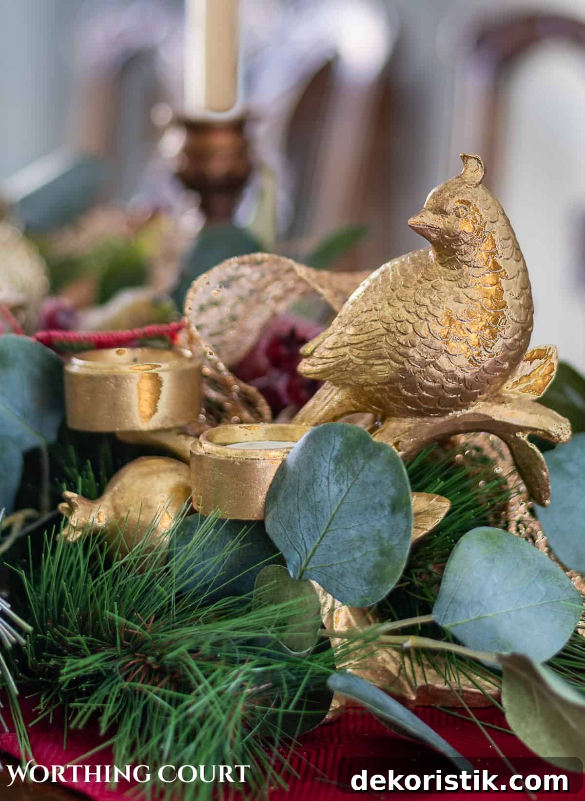 Elegant Christmas Dining Table Centerpiece Ideas 4 An elegant, but easy Christmas centerpiece made with faux greenery and sugared fruit swags. Includes green, burgundy and gold ribbon, gold candlesticks and white candles.