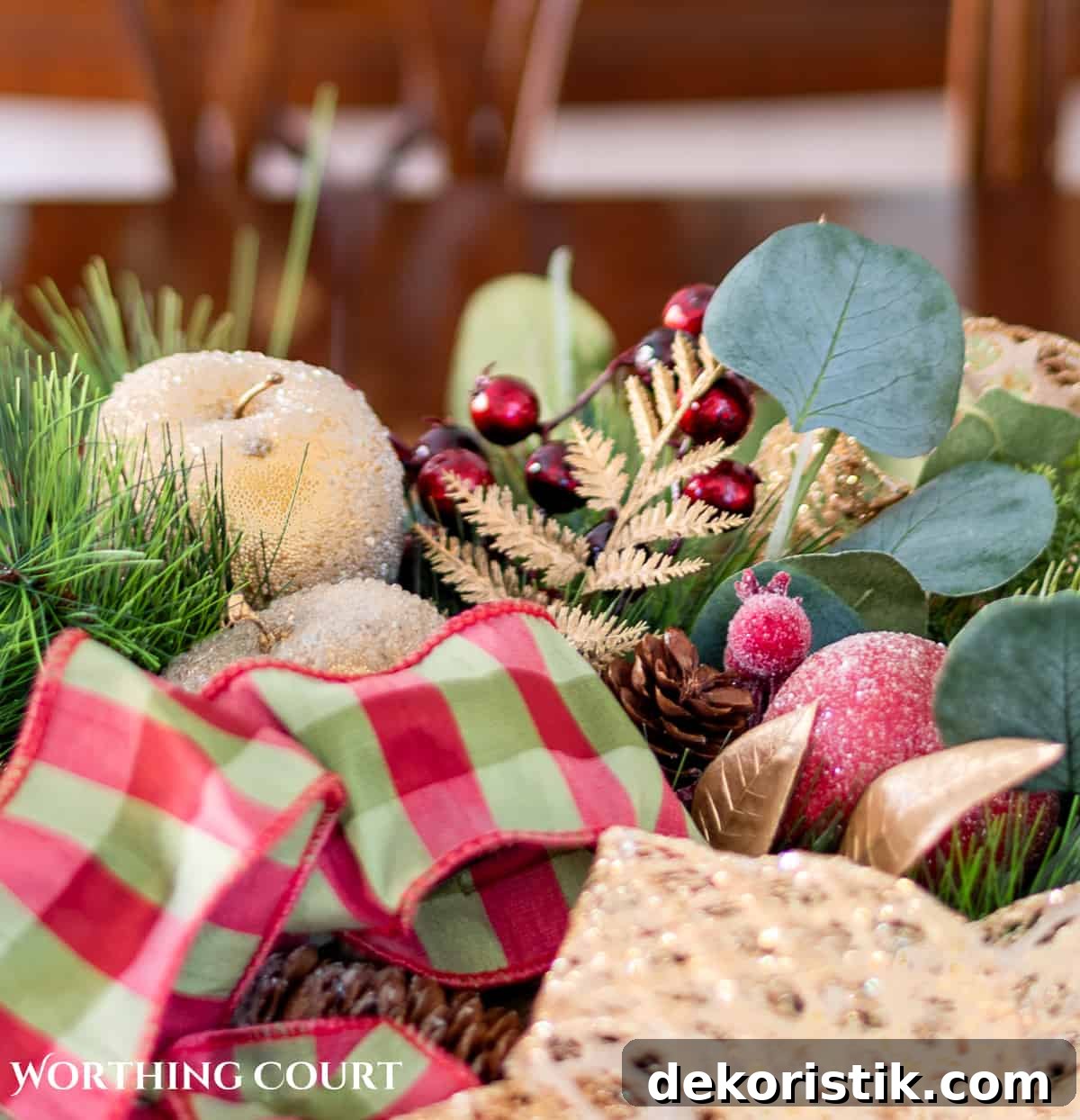 Elegant Christmas Dining Table Centerpiece Ideas 5 An elegant, but easy Christmas centerpiece made with faux greenery and sugared fruit swags. Includes green, burgundy and gold ribbon, gold candlesticks and white candles.