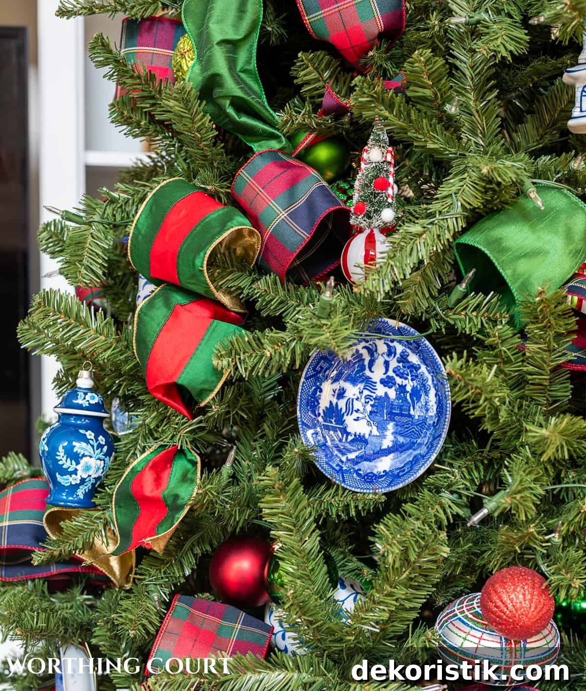 red, green and blue and white traditional decorations on a Christmas tree