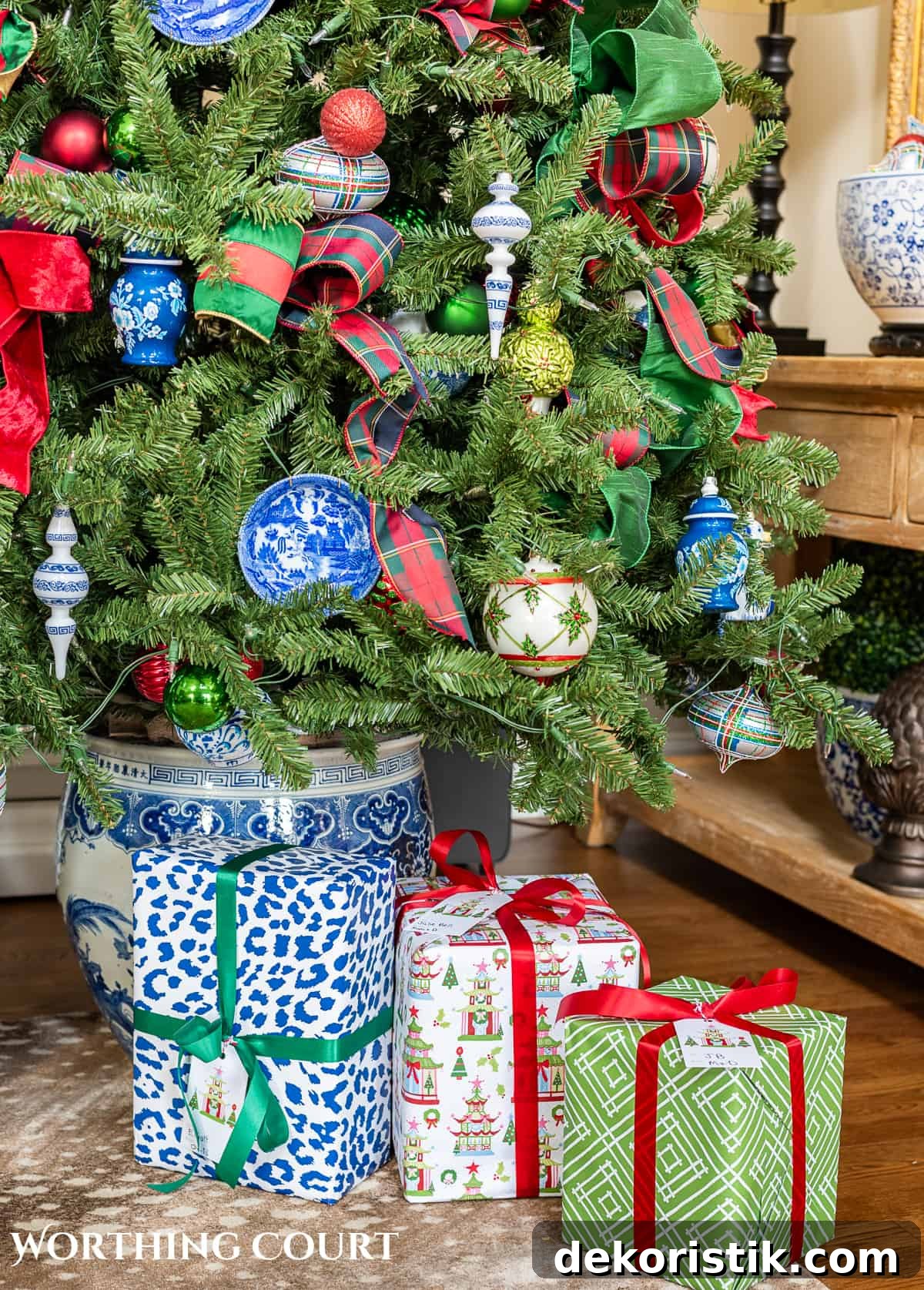 gifts at base of Christmas tree with traditional decorations and presents wrapped in colorful Christmas wrapping paper