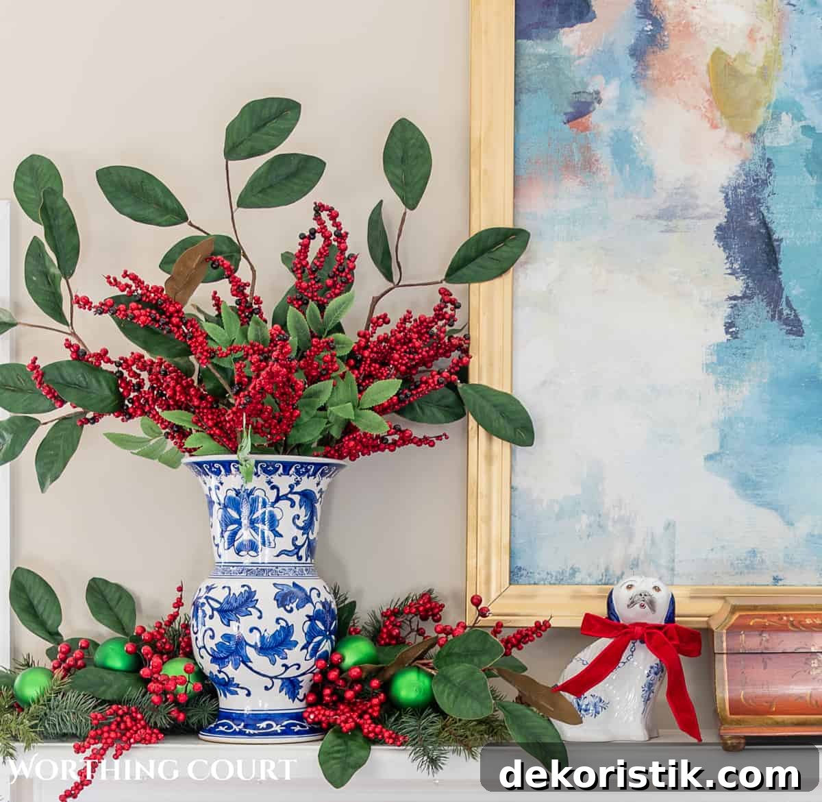 fireplace mantel with abstract art above and traditional Christmas decorations mixed with chinoiserie decor items