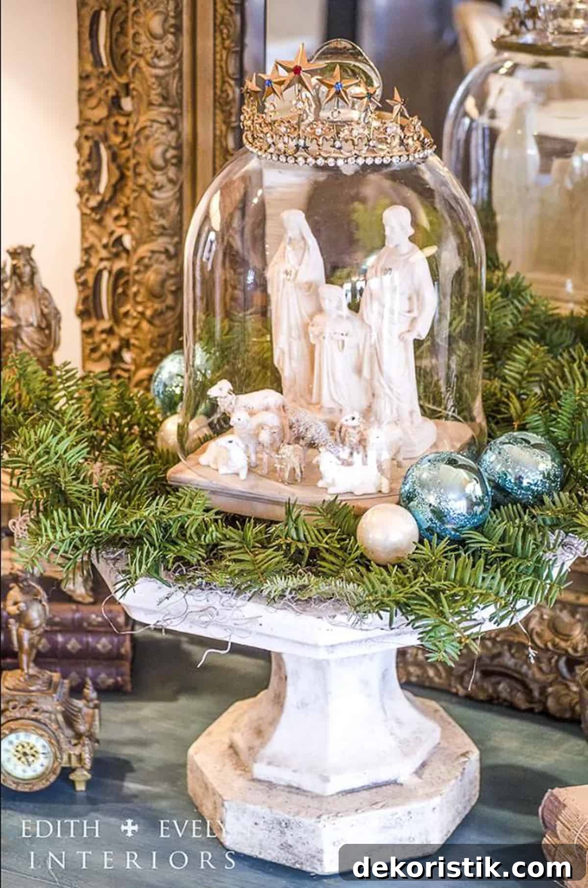 nativity set under a glass cloche on a cake stand