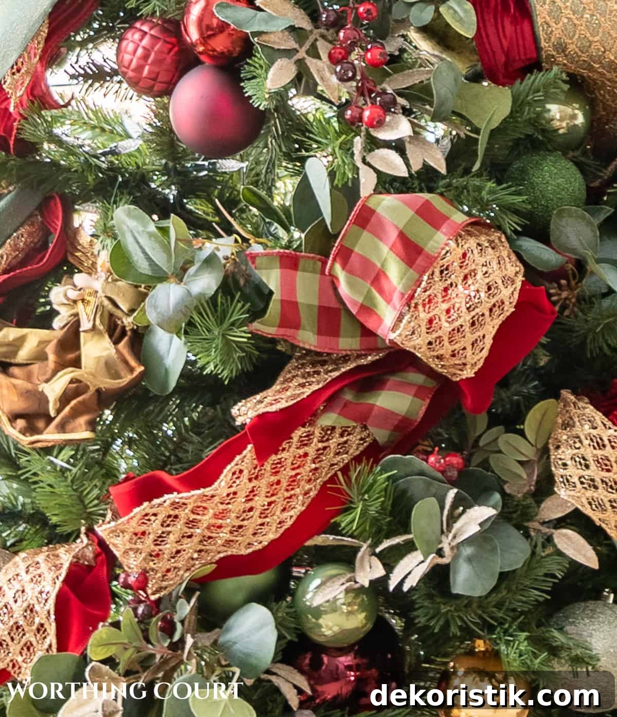 burgundy, green and gold Christmas ribbons and decorations on a Christmas tree