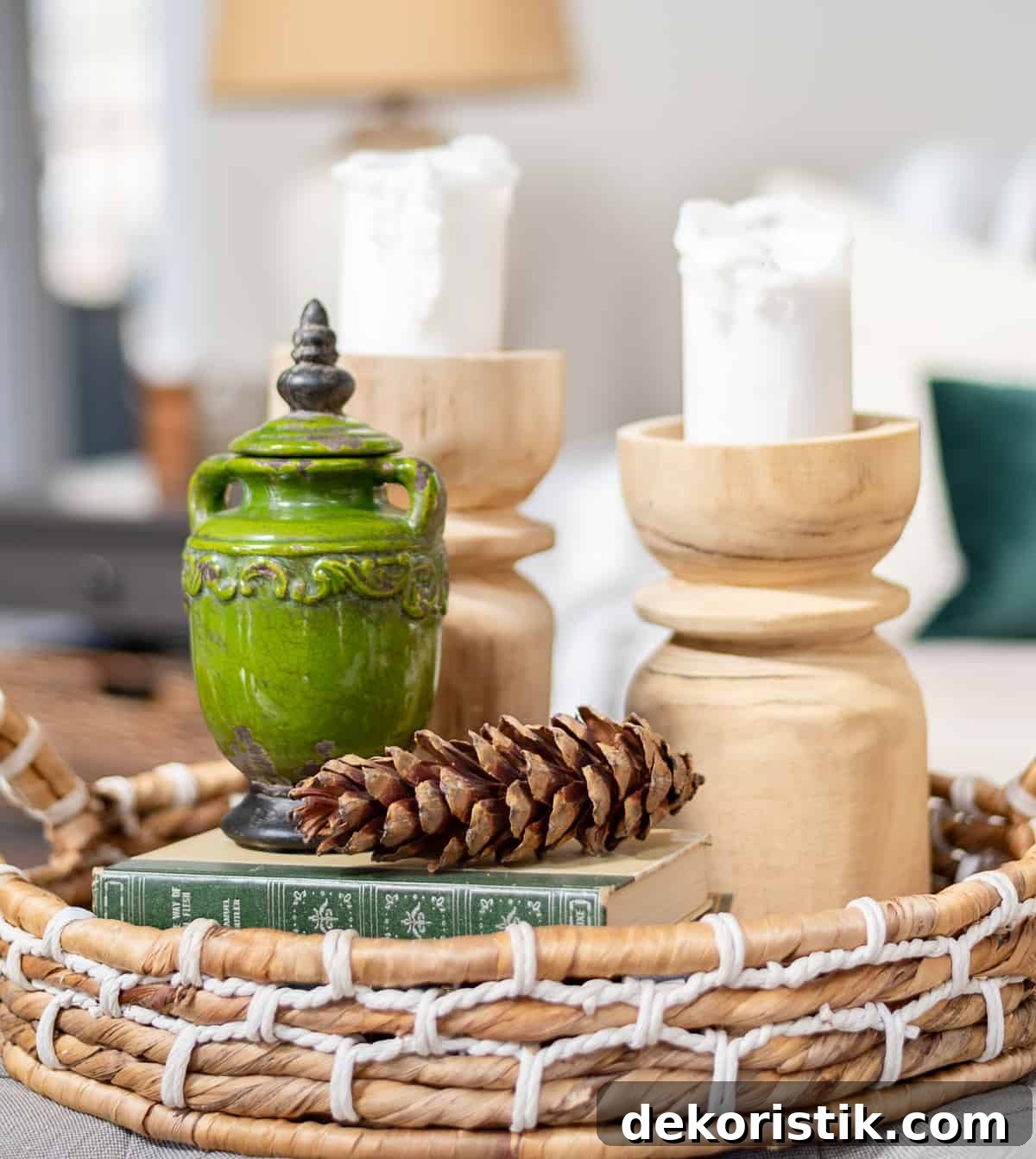 winter vignette in a wicker tray using greena nd white, candles and pinecones
