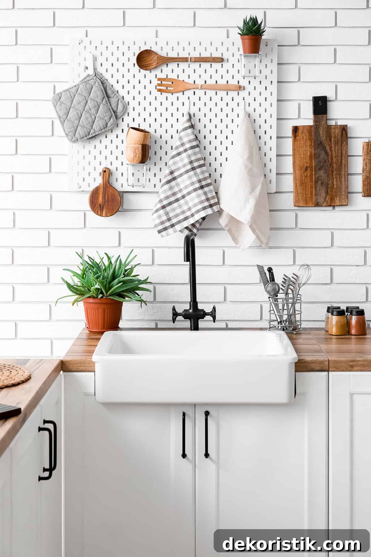 pegboard on a kitchen wall above a white farmhouse sink and cabinets