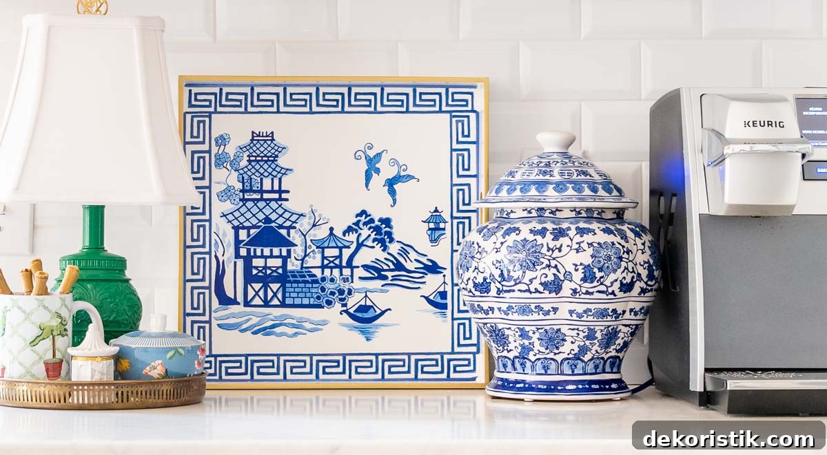 coffee maker, blue and white ginger jar, hand painted blue and white tray and a small green lamp on a kitchen counter