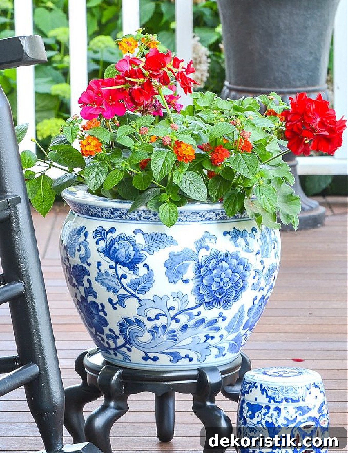 red geraniums in a blue and white chinoiserie planter
