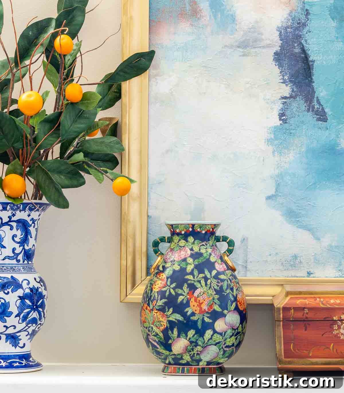 blue and white vase and multi color vase on a mantel with abstract art in the background