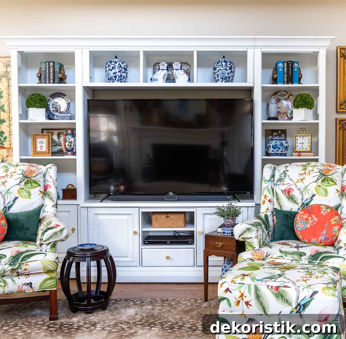 old entertainment center painted white and redecorated with updated traditional and chinoiserie accessories