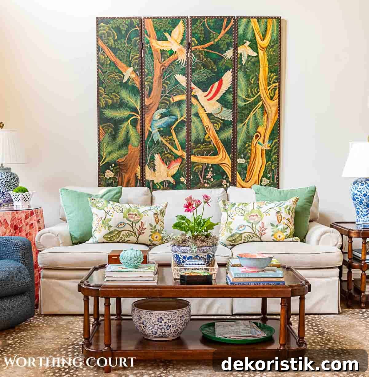 coffee table in front of tan couch with chinese screen on the wall and late summer chinoiserie accessories