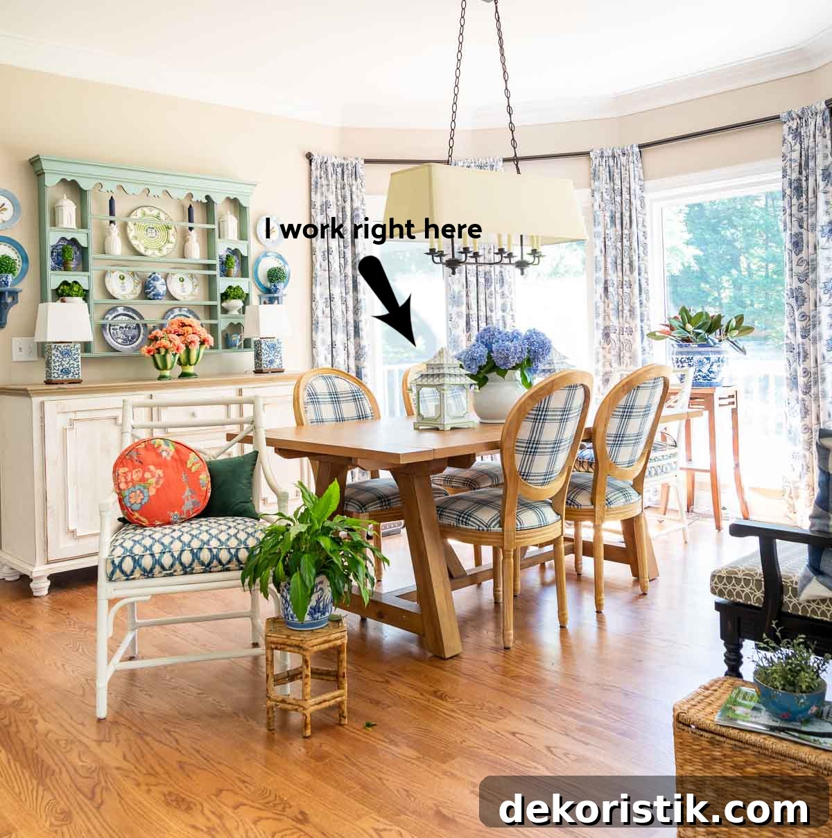 Breakfast room with a large bay window decorated with blue and white cottage style furniture and decor